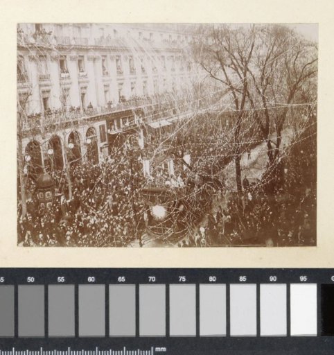 Parade with a float, crowd and confetti, probably in southern France
