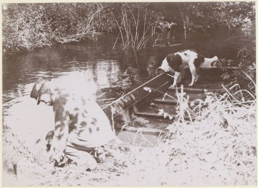 Man and dog by a boat, probably in France