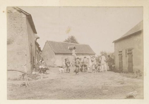Group portrait of a hunting party on a farmyard in France