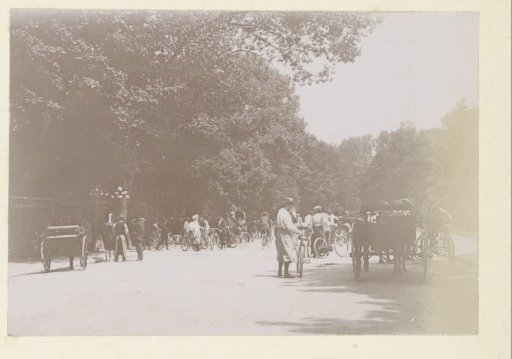 Cyclists and carriages on a road in France