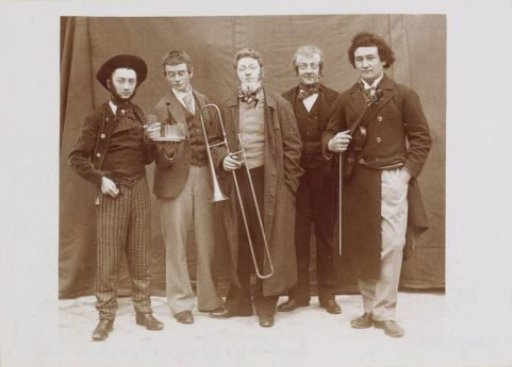 Group portrait of a company in costumes with musical instruments, probably French amateur actors