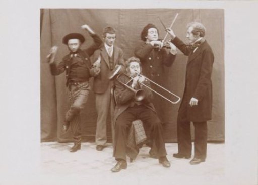 Group portrait of a company in costumes with musical instruments, probably French amateur actors