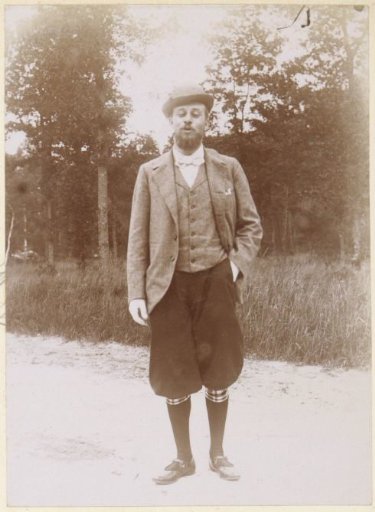 Man posing in plus fours on a road in France