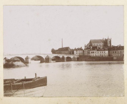 View of a town with a church and a bridge in France
