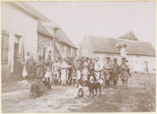 Group portrait of a hunting party on a farmyard in France
