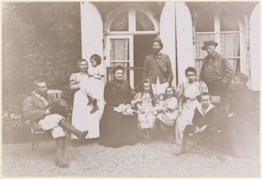 Group portrait of a French family in front of a house