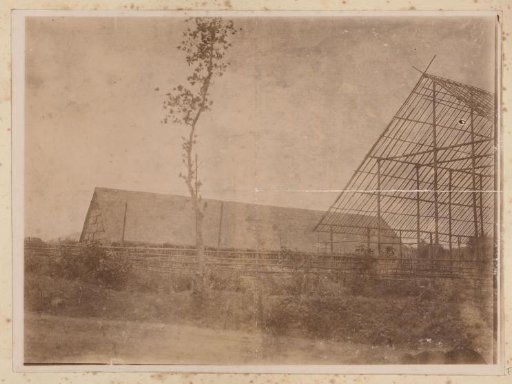 Barn and the skeleton of a barn under construction