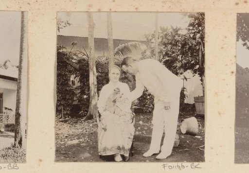 Portrait of a woman with a monkey on her lap and a man