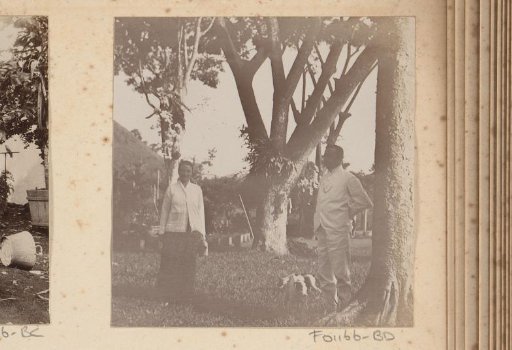 Dutch man and woman with dog in a garden