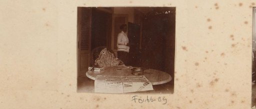 Dutch woman by a table with newspaper