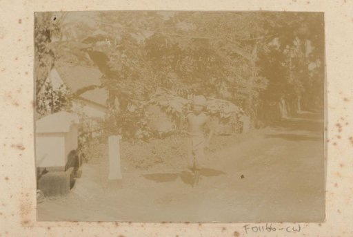 Boy with carrying pole and two baskets on his shoulder
