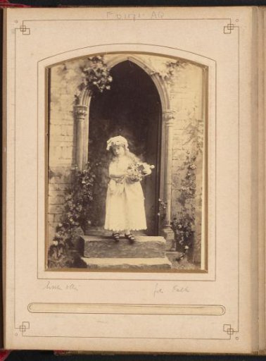 Portrait of a girl with flowers and Bible in a church portal