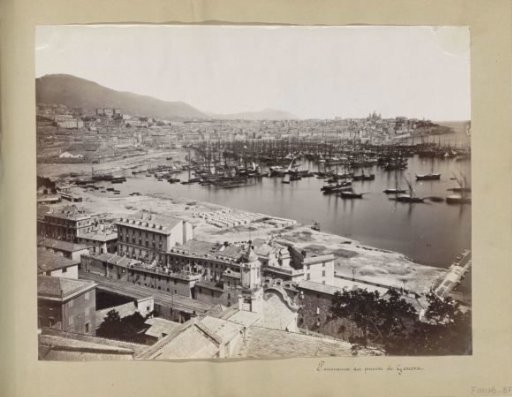 Panoramic photograph of buildings and ships in the harbour of Genoa