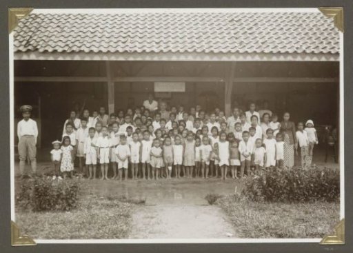 Group portrait of children and teachers in front of a day care facility in Lampong