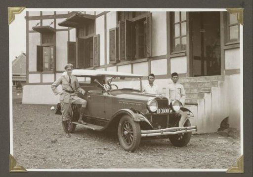 Deputy regional leader of the police and Indonesian staff in front of a service car in Lampong