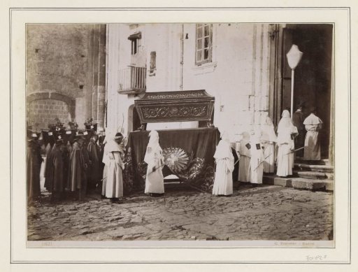 Funeral Procession of Monks with Pointed Hoods at the Entrance of a Church in Italy