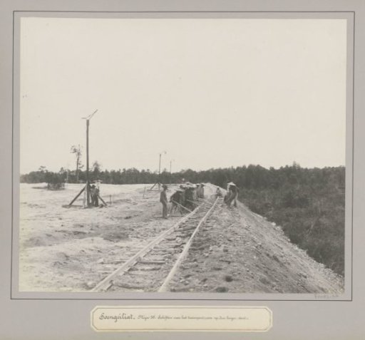 Workers moving railway tracks at a tin company in Soengeiliat