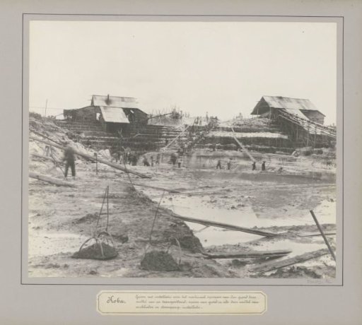 View of a tin mine in Koba with conveyor belt, pump installation and miners