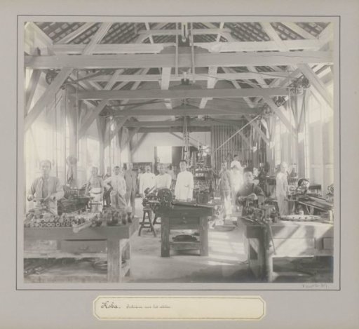 Workers posing in a workshop of a tin company in Koba