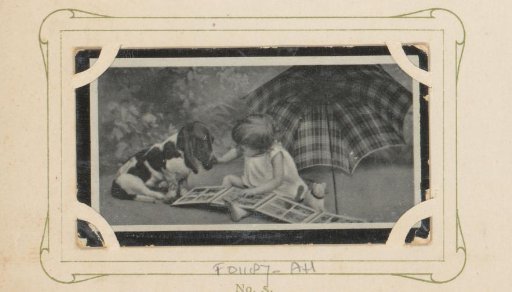 Child showing an album to a dog