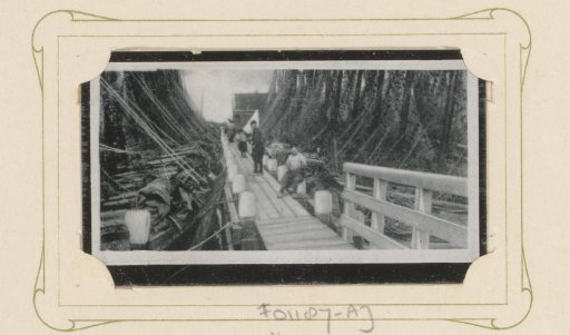 Men on a Jetty in a Harbor