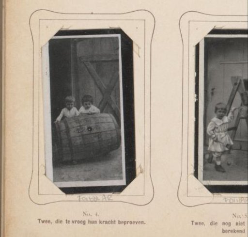 Two children pushing a barrel