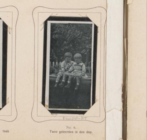 Two Children Reading a Book in the Garden
