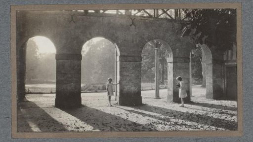 Two children photographing near arches