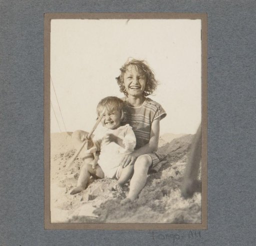 Two children playing in the sand