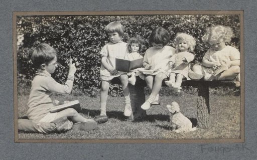 Children playing outside with dolls