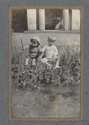 Two children by a ditch
