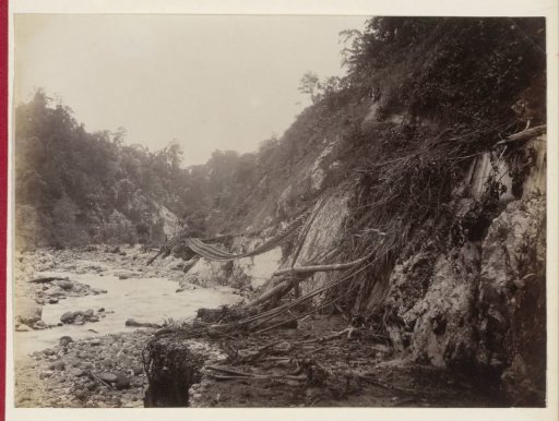 Destroyed railway line near a riverbed in the Dutch East Indies