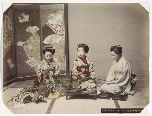 Three Japanese women arranging flowers