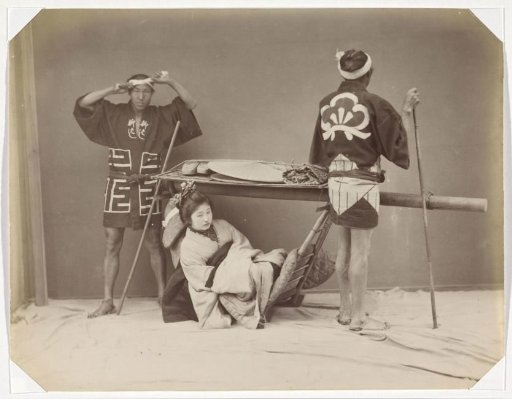 Japanese woman in a palanquin with two bearers