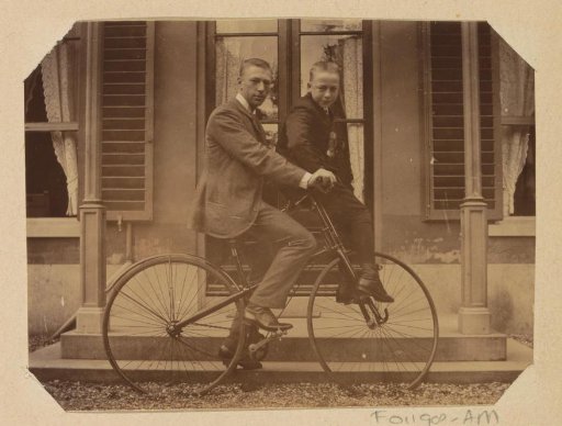 Portrait of an unknown man and a boy on a bicycle