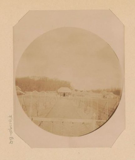 View of a country house from a path surrounded by fields