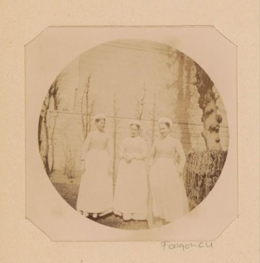 Portrait of three unknown maids in a garden