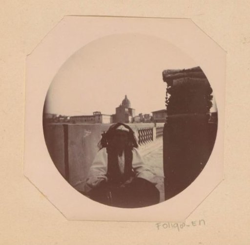 Street vendor with wares at a balustrade along the Arno in Florence