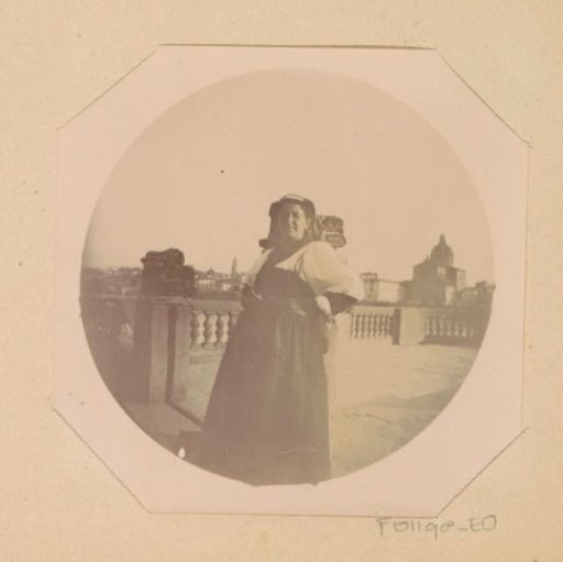 Portrait of a street vendor with wares at a balustrade along the Arno in Florence