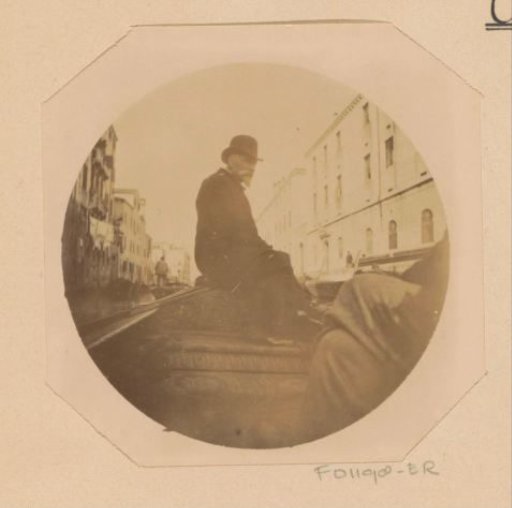 Portrait of a man on the bow of a gondola in Venice