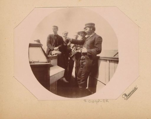 Three boys and two men, presumably teacher and skipper, during an excursion of the Public Commercial School to Berlin and the Baltic Sea