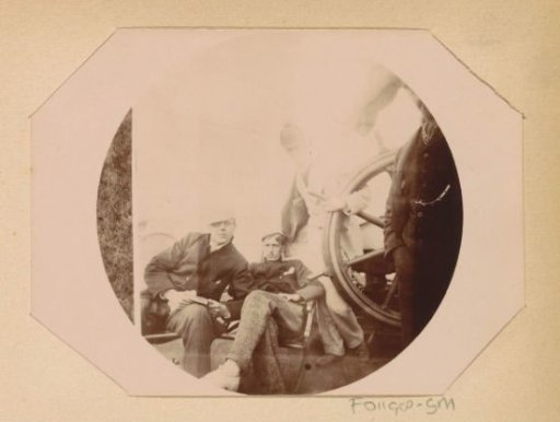 Three boys from the Public Trade School on the deck of a ship during an excursion to the Baltic Sea, one of them, possibly Willem Frederik Piek Jr., posing behind a ship's wheel