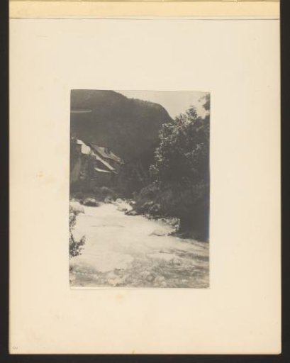 View of a mountain stream with houses in the background