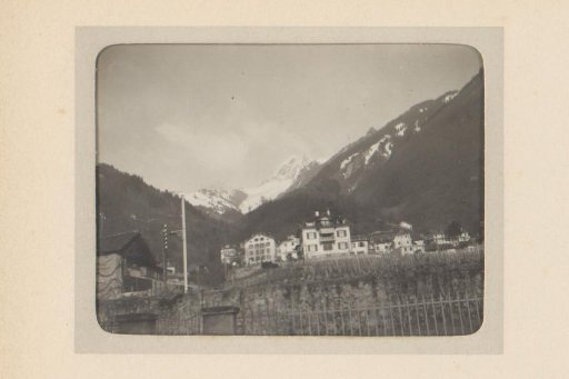 View of a Mountain Village with a Snow-Capped Peak in the Background