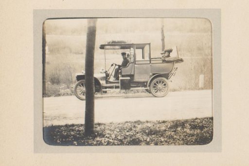 Automobile with Chauffeur, a Man and Woman in the Rear