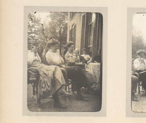 Three women biting into a fruit
