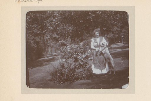 Portrait of a woman with a dog in a garden