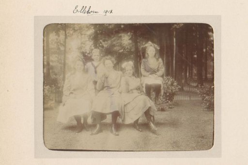 Group portrait of four girls and a boy in a garden