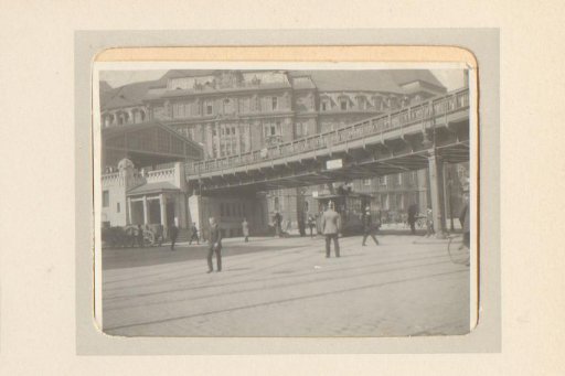 Street scene with tram and elevated railway line