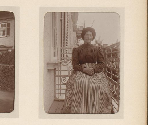 Portrait of an unknown woman, seated on a porch